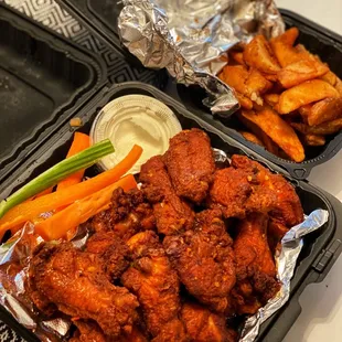 Naked wings in hot jet lag sauce and potato wedges