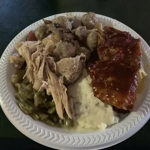 Mashed potatoes, turkey, ham, ribs, meat balls with mushrooms, and green beans and beef stroganoff.
