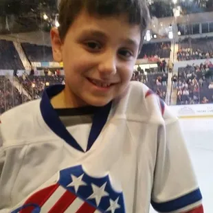 a young boy in a hockey jersey
