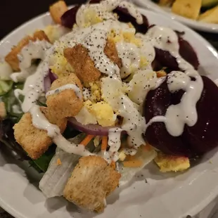 Green salad, eggs, beets, red onion, croutons, and crackers. Ranch dressing, of course...fresh fruit. Actually a nice salad.