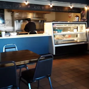 a restaurant with a counter and chairs