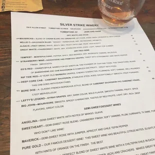 a menu and a glass of wine