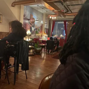 people sitting at tables in a restaurant