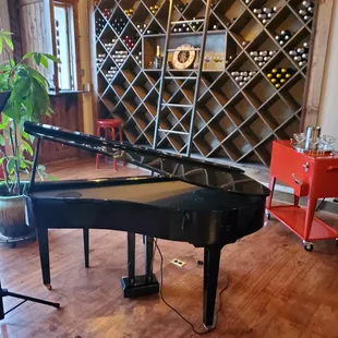 a grand piano in a wine cellar
