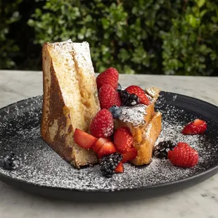 French Toast topped with powdered sugar and fruit