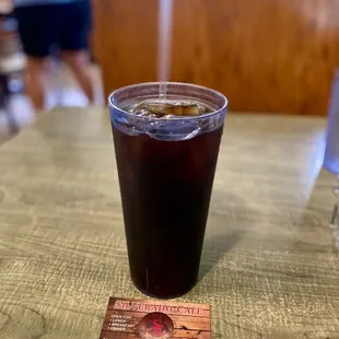 a drink in a plastic cup on a table