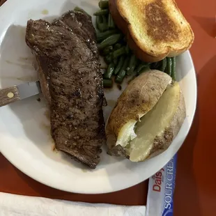 10oz KC strip steak dinner with baked potato, green beans and Texas toast