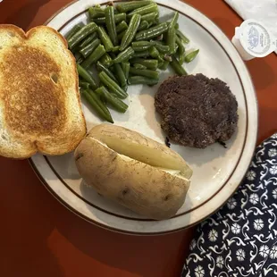 Hamburger steak with baked potato, green beans and Texas toast