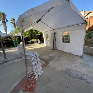 12x20 canopy with 1 wall and light. Tables and chairs.
