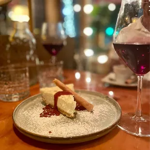 a plate of dessert and a glass of wine