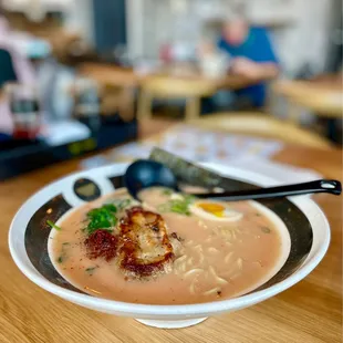 a bowl of ramen and a spoon