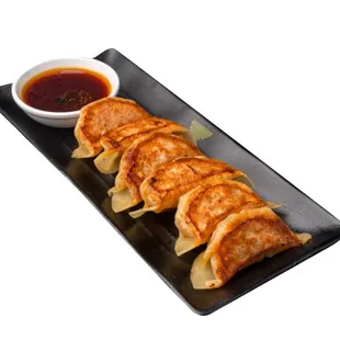 Handmade Grilled Gyoza - From making our pork and vegetable filling from scratch to hand folding them, they are a must try!