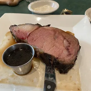 a piece of meat on a plate with sauce