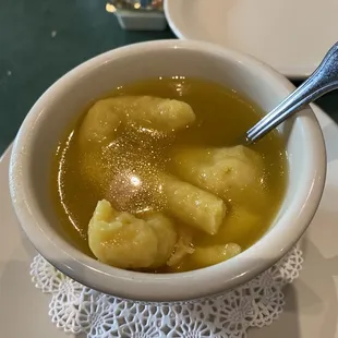 a bowl of soup with dumplings