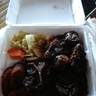 Oxtails with cabbage with rice and peas and plantains.