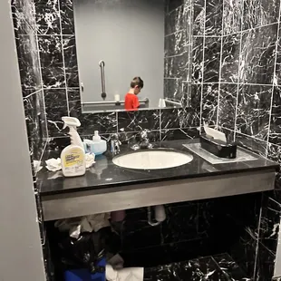 Leftover cleaning supplies.  Overflowing trash