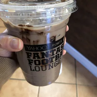 a hand holding a cup of coffee