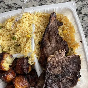 Lamb chops, yellow rice, and plantains