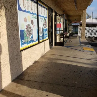 a sidewalk in front of a store