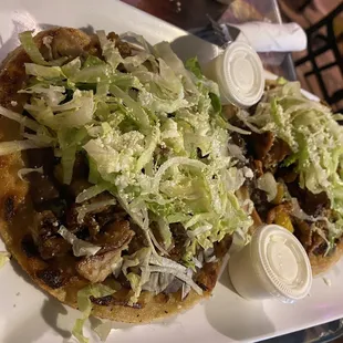 a taco with lettuce and onions