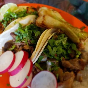 Tacos served with grilled Mexican green onions.