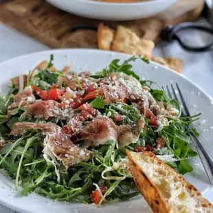 a plate of salad and bread