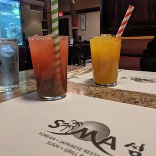 Pink drink is strawberry green tea with kiwi popping bubbles. The orange is mango green tea with passion fruit popping bubbles.
