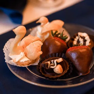 a plate of chocolate covered strawberries