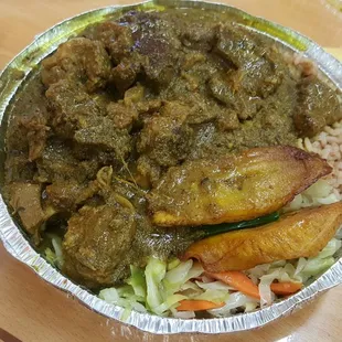 Large plate of curry goat w/rice and pease. A side of cabbage &amp; sweet plaintains included.