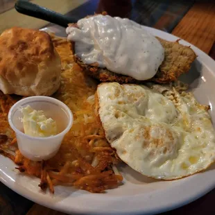Chicken Fried Steak with Eggs over Medium, Hashbrowns and a Biscuit.