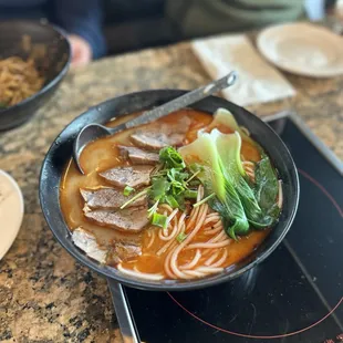 a bowl of soup with meat and vegetables