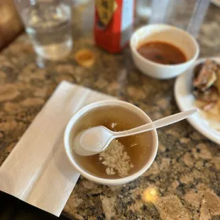 a bowl of soup and two plates of food