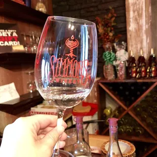 a hand holding a wine glass