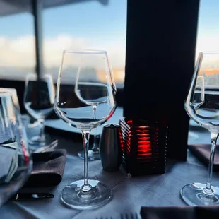 a table setting with wine glasses