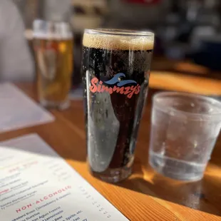 a pint of beer and a menu