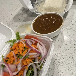 a salad in a styrofoam container