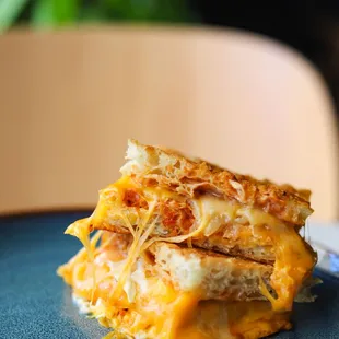 a grilled cheese sandwich on a blue plate