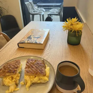 Scrambled eggs sandwich with avocado, drip coffee