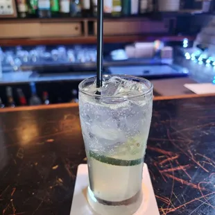 a drink with a straw and a slice of lime