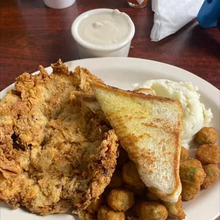 a plate of fried chicken, mashed potatoes, and a sandwich