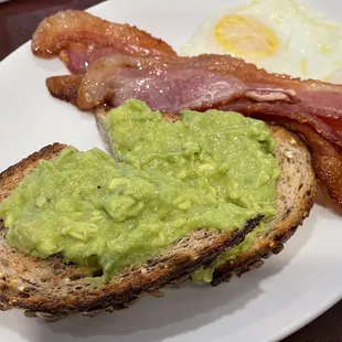 bacon, eggs, and guacamole on toast