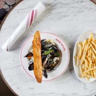 Moules Frites cooked in a vermouth cream sauce, toasted baguette.