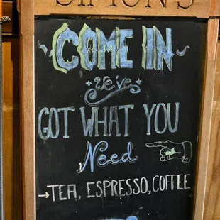 a chalk board with a sign that says come in and get what you need