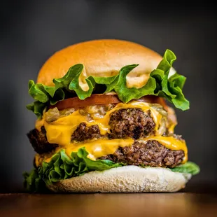 a hamburger with cheese and lettuce