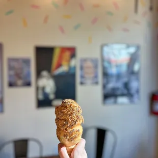 a hand holding a doughnut