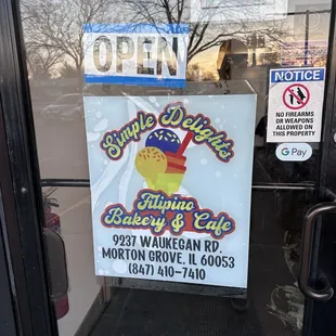 a sign in the window of a bakery