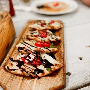 a wooden cutting board with a pizza on it