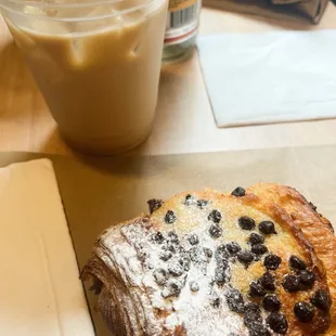 chocolate chip almond croissant with an iced chai latte