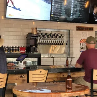 two men sitting at a bar