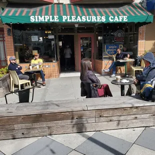 people sitting at tables outside